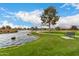 Beautiful lake view with bench seating, ideal for relaxation and enjoying the scenic community surroundings at 42911 W Magic Moment Dr, Maricopa, AZ 85138