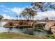 Scenic pond featuring a rock waterfall, creating a tranquil and picturesque community setting at 42911 W Magic Moment Dr, Maricopa, AZ 85138