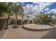 Paver stone patio with firepit, large umbrella, and backyard pool with lush landscaping and mature trees at 4576 E Waterman St, Gilbert, AZ 85297