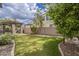 Expansive backyard with lush green grass, built in BBQ, and manicured landscaping at 4576 E Waterman St, Gilbert, AZ 85297