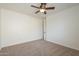 Well-lit bedroom features neutral carpeting, ceiling fan and access to a walk in closet, perfect for restful nights at 4576 E Waterman St, Gilbert, AZ 85297