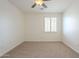 Simple bedroom design features neutral carpeting, window with shutters, and a ceiling fan at 4576 E Waterman St, Gilbert, AZ 85297