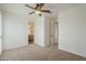 Empty bedroom with neutral carpeting shows multiple doorways and a ceiling fan ready for personal touches at 4576 E Waterman St, Gilbert, AZ 85297