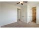 Spacious bedroom features neutral carpeting, architectural wall trim, and access to both bathrooms and closets at 4576 E Waterman St, Gilbert, AZ 85297