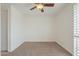 Empty bedroom featuring neutral carpet, ceiling fan, and a light-filled feel due to white walls at 4576 E Waterman St, Gilbert, AZ 85297