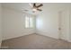 Neutral bedroom with a ceiling fan, window with shutters, and neutral carpeting, ready for personalization at 4576 E Waterman St, Gilbert, AZ 85297