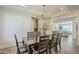 Dining room with modern chandelier, tile floors, and views to a living space at 4576 E Waterman St, Gilbert, AZ 85297