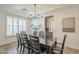 Dining room with modern chandelier, tile floors, and windows for natural light at 4576 E Waterman St, Gilbert, AZ 85297