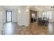 Spacious foyer transitioning to a dining room with a stone accent wall and chandelier at 4576 E Waterman St, Gilbert, AZ 85297