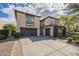 Spacious stucco home featuring multiple garages, a paved driveway, and mature landscaping at 4576 E Waterman St, Gilbert, AZ 85297