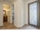 Elegant foyer with a decorative wrought iron front door and access to a half bath at 4576 E Waterman St, Gilbert, AZ 85297