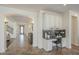 Hallway view of a built-in office nook with white cabinetry and granite countertops at 4576 E Waterman St, Gilbert, AZ 85297
