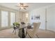 Inviting home office features neutral carpet, modern desk, chairs, and ample natural light from patio doors at 4576 E Waterman St, Gilbert, AZ 85297