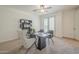 Bright home office with neutral carpet, a modern desk, a decorative bookshelf, and a patio view at 4576 E Waterman St, Gilbert, AZ 85297
