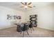 Inviting home office featuring neutral carpet, modern desk, chairs, and a decorative bookshelf at 4576 E Waterman St, Gilbert, AZ 85297