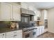 Updated kitchen with stainless steel appliances, white cabinetry, and granite countertops at 4576 E Waterman St, Gilbert, AZ 85297