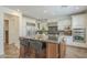 Kitchen with a large center island featuring bar seating, stainless steel appliances, and white cabinets at 4576 E Waterman St, Gilbert, AZ 85297