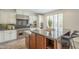 Kitchen with a large island, stainless steel appliances, and plantation shutters over the sink at 4576 E Waterman St, Gilbert, AZ 85297