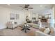 Comfortable living room area with views into the kitchen boasts neutral decor and a ceiling fan at 4576 E Waterman St, Gilbert, AZ 85297