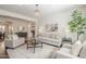 Cozy living room featuring neutral furnishings, a center table, and a view into the dining area at 4576 E Waterman St, Gilbert, AZ 85297