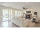 Open living room features a stone fireplace, ceiling fan, and patio doors leading to the outdoor pool area at 4576 E Waterman St, Gilbert, AZ 85297