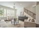 Bright living room with comfortable seating, stylish chandelier, and ample natural light from plantation shutters at 4576 E Waterman St, Gilbert, AZ 85297