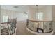 Loft overlooking staircase featuring neutral carpet, white walls, and modern fixtures at 4576 E Waterman St, Gilbert, AZ 85297