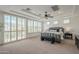 Bright main bedroom with plantation shutters, tray ceiling, and neutral decor at 4576 E Waterman St, Gilbert, AZ 85297