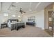 Spacious main bedroom featuring a tray ceiling, plush carpeting, and stylish furniture at 4576 E Waterman St, Gilbert, AZ 85297