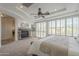 Bright main bedroom with stone fireplace and plantation shutters at 4576 E Waterman St, Gilbert, AZ 85297
