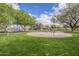 A colorful playground area with green grass, trees, and playground equipment offers children a fun outdoor space at 4576 E Waterman St, Gilbert, AZ 85297