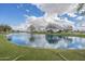 Community pond and park, with large mature trees on a sunny day with blue skies at 4576 E Waterman St, Gilbert, AZ 85297