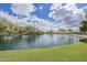 Scenic pond view with lush green banks, mature trees, and clear water, offering a tranquil neighborhood setting at 4576 E Waterman St, Gilbert, AZ 85297
