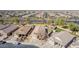 Aerial view showcasing well-kept homes, desert landscaping, and community street at 4610 S Hassett Cir, Mesa, AZ 85212