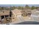 An aerial view showcasing the home, its well-maintained roof, and the neighborhood at 4610 S Hassett Cir, Mesa, AZ 85212