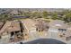 Aerial view of a stucco home with desert landscaping, surrounded by similar homes in a well-planned neighborhood at 4610 S Hassett Cir, Mesa, AZ 85212