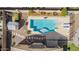 Aerial view of a private backyard oasis featuring a sparkling blue pool and meticulously landscaped yard at 4610 S Hassett Cir, Mesa, AZ 85212