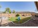 Spacious backyard featuring well-maintained landscaping and a charming slide at 4610 S Hassett Cir, Mesa, AZ 85212