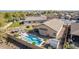 Aerial shot of a backyard with a cozy pool, a shed, a patio, and lush greenery within a block fence at 4610 S Hassett Cir, Mesa, AZ 85212