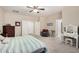 Bright bedroom featuring neutral walls, carpet, ceiling fan, and ensuite bathroom with generous closet space at 4610 S Hassett Cir, Mesa, AZ 85212