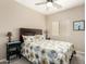 Cozy bedroom with floral bedding, bedside tables, and a window offering natural light at 4610 S Hassett Cir, Mesa, AZ 85212