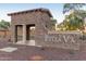 Stone entrance to Bella Via community with lush landscaping and a welcoming design at 4610 S Hassett Cir, Mesa, AZ 85212