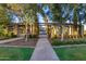 Beautiful community fountain area with covered seating, lush landscaping, and concrete walkways at 4610 S Hassett Cir, Mesa, AZ 85212