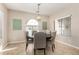Formal dining room featuring a round table with upholstered chairs and an elegant pendant light fixture at 4610 S Hassett Cir, Mesa, AZ 85212