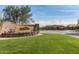 Community entrance to Bellavia with stone signage, mature landscaping, and gated entry at 4610 S Hassett Cir, Mesa, AZ 85212