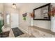Inviting entryway with neutral walls, tile floors, decorative mirror, and coat rack at 4610 S Hassett Cir, Mesa, AZ 85212