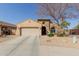 Charming single-story home with a well-maintained front yard and attached two-car garage at 4610 S Hassett Cir, Mesa, AZ 85212