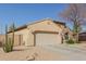 Charming single-story home with a two-car garage and low maintenance desert landscaping at 4610 S Hassett Cir, Mesa, AZ 85212