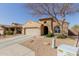 Charming home exterior featuring a stucco finish, tile roof, and desert landscaping at 4610 S Hassett Cir, Mesa, AZ 85212