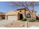 Charming single-story home featuring a two-car garage and low maintenance desert landscaping at 4610 S Hassett Cir, Mesa, AZ 85212
